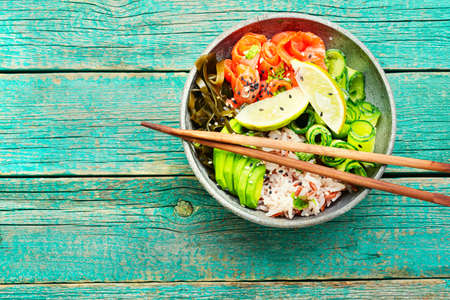 Hawaiian salmon poke bowl with rice, seaweed and avocado