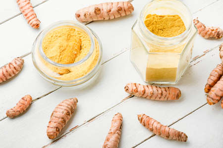Fresh turmeric root or rhizome and turmeric powderの写真素材