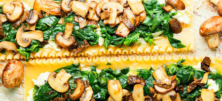 Lasagna with mushrooms, champignons, cheese and spinach. Traditional Italian food.
