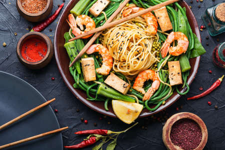 Delicious spaghetti with shrimps, halloumi and cow-pea in plateの写真素材