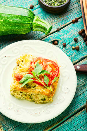 Delicious zucchini and tomato omelet on plate.Summer snack.の写真素材