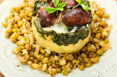 Polenta with fried mushrooms, mash and spinach.Close upの写真素材