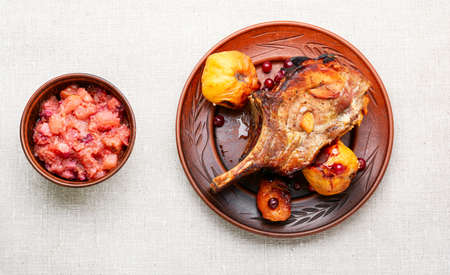 Roasted pork meat steak with quince. Steak on the bone.の写真素材