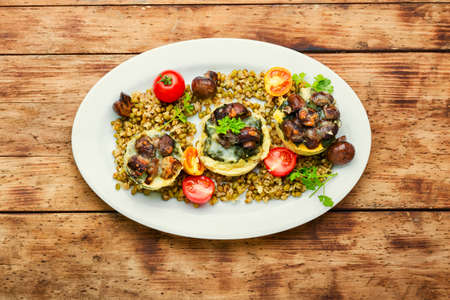 Polenta or corn porridge with mushrooms and spinach. Italian cuisine.の写真素材