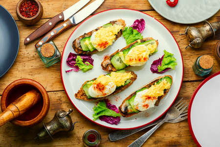 Poached egg, cucumber and stewed mushrooms.Breakfast with eggs benedict.Classic Egg Benedict