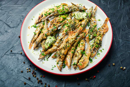 Fried capelin fish with herbs and lemon zestの写真素材