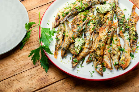Roasted capelin fish with herbs and lemon zestの写真素材