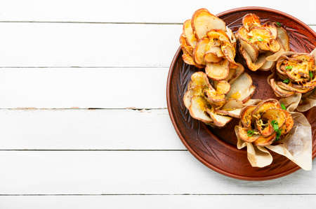 Baked potatoes with bacon and cheese on a plateの写真素材