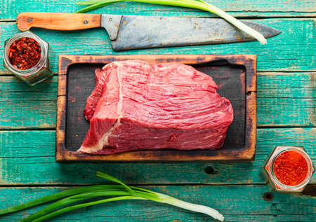 Fresh raw beef meat on wooden cutting boardの写真素材