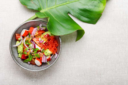 Asian salad of crab sticks, red caviar and avocado. Space for text
