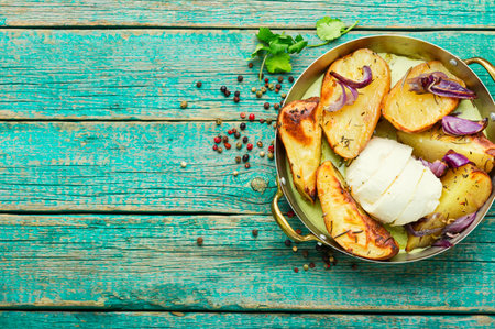 Homemade roasted potatoes with mozzarella cheese and onions.Copy spaceの写真素材