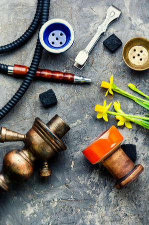Hookah mouthpiece and hookah cup with narcissus tobacco. Shisha on flower tobaccoの写真素材