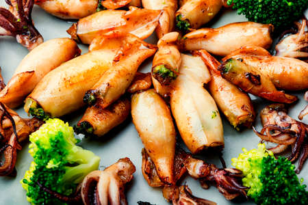 Baked squid stuffed with broccoli.Grilled calamari with vegetables.Seafoodの写真素材
