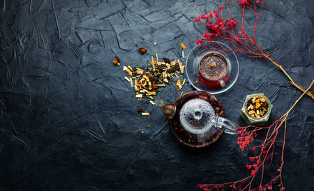 Fragrant flower tea in a glass teapot. Space for textの写真素材