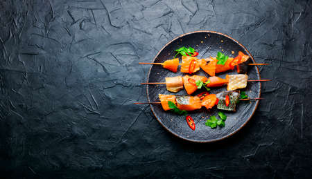 Kebabs from dried and salmon on wooden skewers. Salted salmon slicesの写真素材