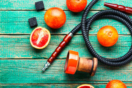 Oriental smoking hookah or shisha with tobacco with grapefruit flavor.Modern fruit shisha with...