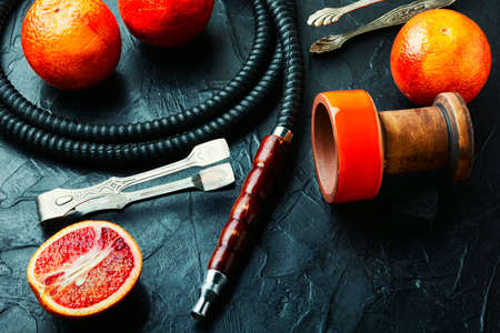 Oriental hookah or shisha with tobacco with grapefruit aroma.East smoking kalian