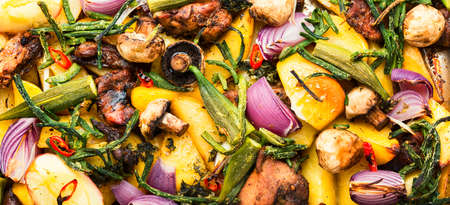 Baked meat with potatoes, apples, mushrooms and okra. Roasted meat with vegetables.の写真素材