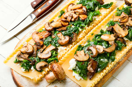 Lasagna with mushrooms, champignons, cheese and spinach. Traditional Italian food.の写真素材