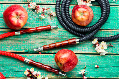 Modern shisha hookah on tobacco with apple tasty.Apple shisha.Smoking a hookah.Making shisha for smokingの写真素材