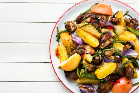 Baked meat with potatoes, apples, mushrooms and okra. Roasted meat with vegetables.の写真素材