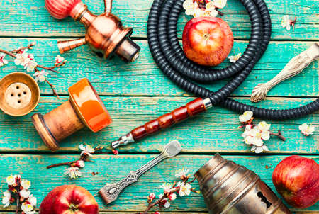Oriental smoking hookah on tobacco with apple flavor.Apple shisha.Smoking a hookahの写真素材