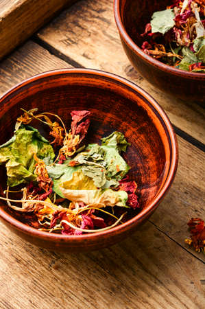 Dried leaves and flowers of nasturtium on rustic wooden table.Medicinal herbs.Herbal medicine.の写真素材