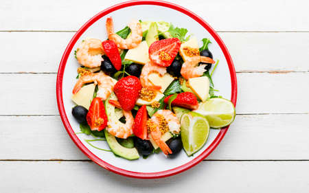 Diet salad with shrimps, strawberries, avocado and green.の写真素材