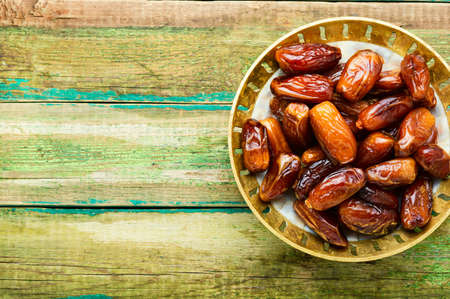 Dried sweet dates in bowl.Organic dates.Sweet food.Space for text