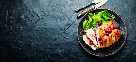Roasted chicken breast with cherry sauce. Baked chicken meat in berries. Flat lay with copy spaceの写真素材