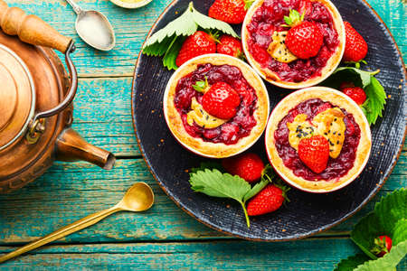 Tasty tartlets with berry jam.Cake with strawberries.Sweets for teaの写真素材