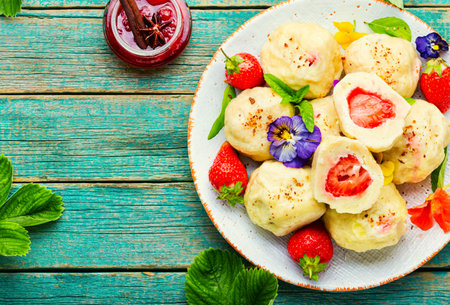 Traditional european dumplings with berries. Dumplings with strawberries or knedlik.Cottage cheese dumplings with strawberryの写真素材