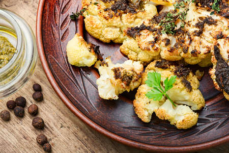 Vegetarian cauliflower steak on old wooden table.Grilled cauliflower vegan.の写真素材