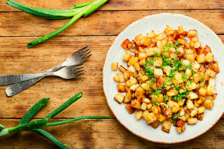 Appetizing fried potatoes.Roasted potatoes on the plateの写真素材
