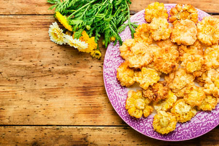 Tasty fried edible flowers. Chrysanthemum flowers in batter.Deep fried flowers.Copy spaceの写真素材