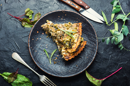 Homemade pie with swiss chard, feta cheese and green peas. Pie with herbs, proper nutrition.の写真素材