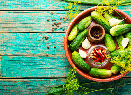 Salted homemade cucumbers old wooden surface.Cooking process.Canned gherkin.Marinated cucumbers.Copy spaceの写真素材