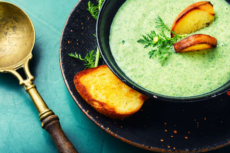 Puree soup, dietary zucchini and herb soup, with toastの写真素材