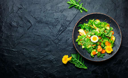 Diet salad with chrysanthemum leaves and avocado. Vegetarian delicious salad. Copy spaceの写真素材