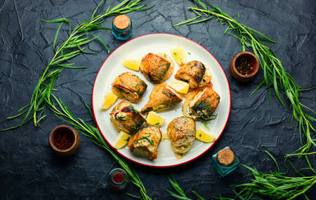 Tasty baked scomber with onions and herbs.Pieces of roasted fish on a plate.Fried mackerel piecesの写真素材