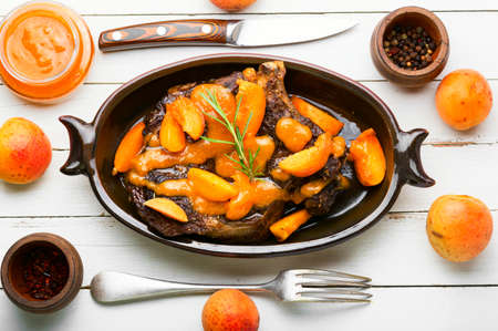 Tasty beef meat in apricot sauce. Veal steak in fruit marinade.の写真素材