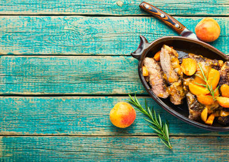 Appetizing beef entrecote in apricot sauce. Space for textの写真素材