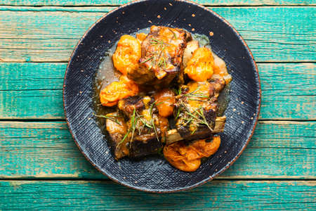 Beef ribs stewed in apricots. Veal meat with fruit sauce