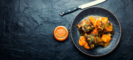 Beef ribs stewed in apricots. Braised meat with fruit sauce. Space for text