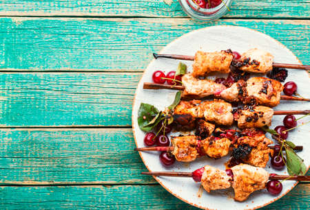 Chicken meat on wooden skewers in cherry sauce.Chicken skewers.Copy spaceの写真素材