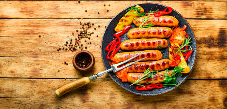 Delicious grilled sausages with grilled vegetables. Sausages fried with pepper.Copy spaceの写真素材