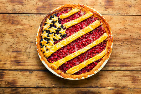 Appetizing homemade pie with red and black currants. Sweet dessert. American flag.American berry pie.の写真素材