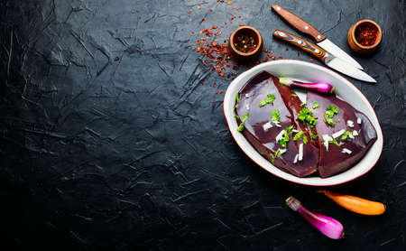 Piece of raw beef liver on the kitchen table.Fresh liver for cookingの写真素材
