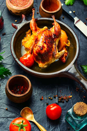 Whole quails roasted in tomato sauce. Fried quails meat.の写真素材