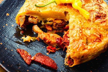 Mexican pie with smoked sausage and chicken. Meat pie.の写真素材